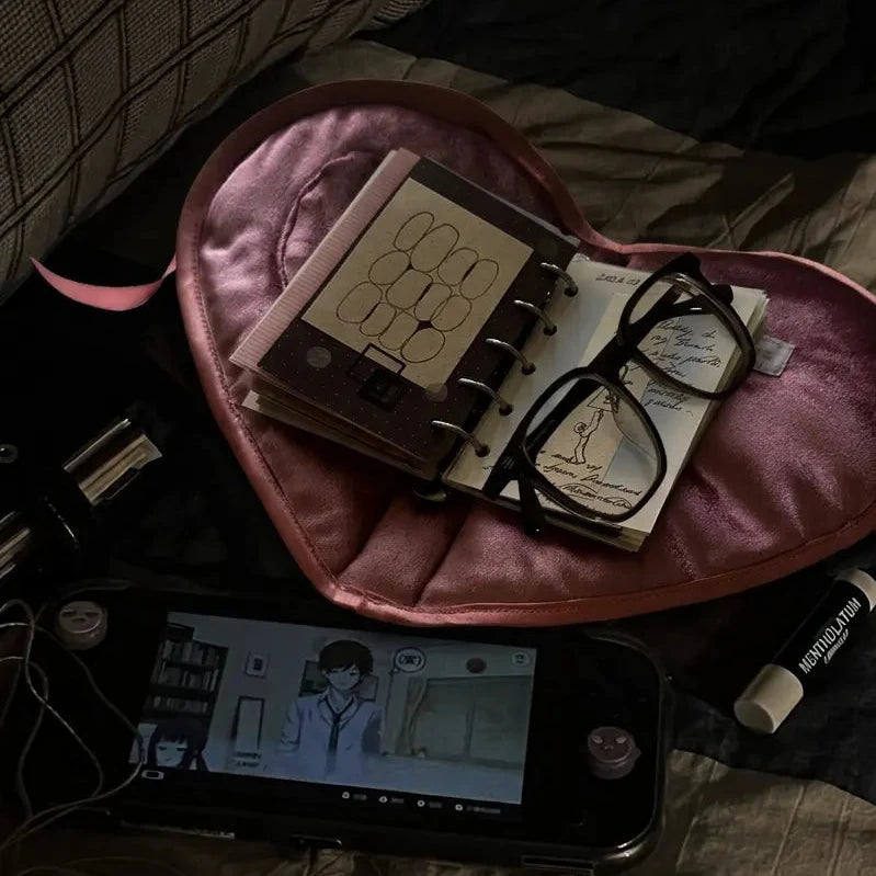 Secret Teatime A7 journal cover in dark pink heart-shaped velvet tray, styled with a ring-bound notebook, glasses, and stationery on a dark moody background