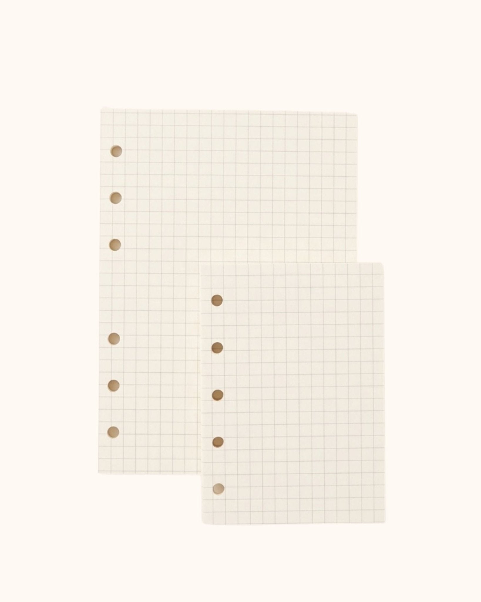 Overhead view of two Kuura premium grid graph paper refill sheets in A6 and A7 sizes with standard 5-hole and 6-hole punching. High-quality, ghosting-resistant paper perfect for neat handwriting, planning, and precise diagrams.