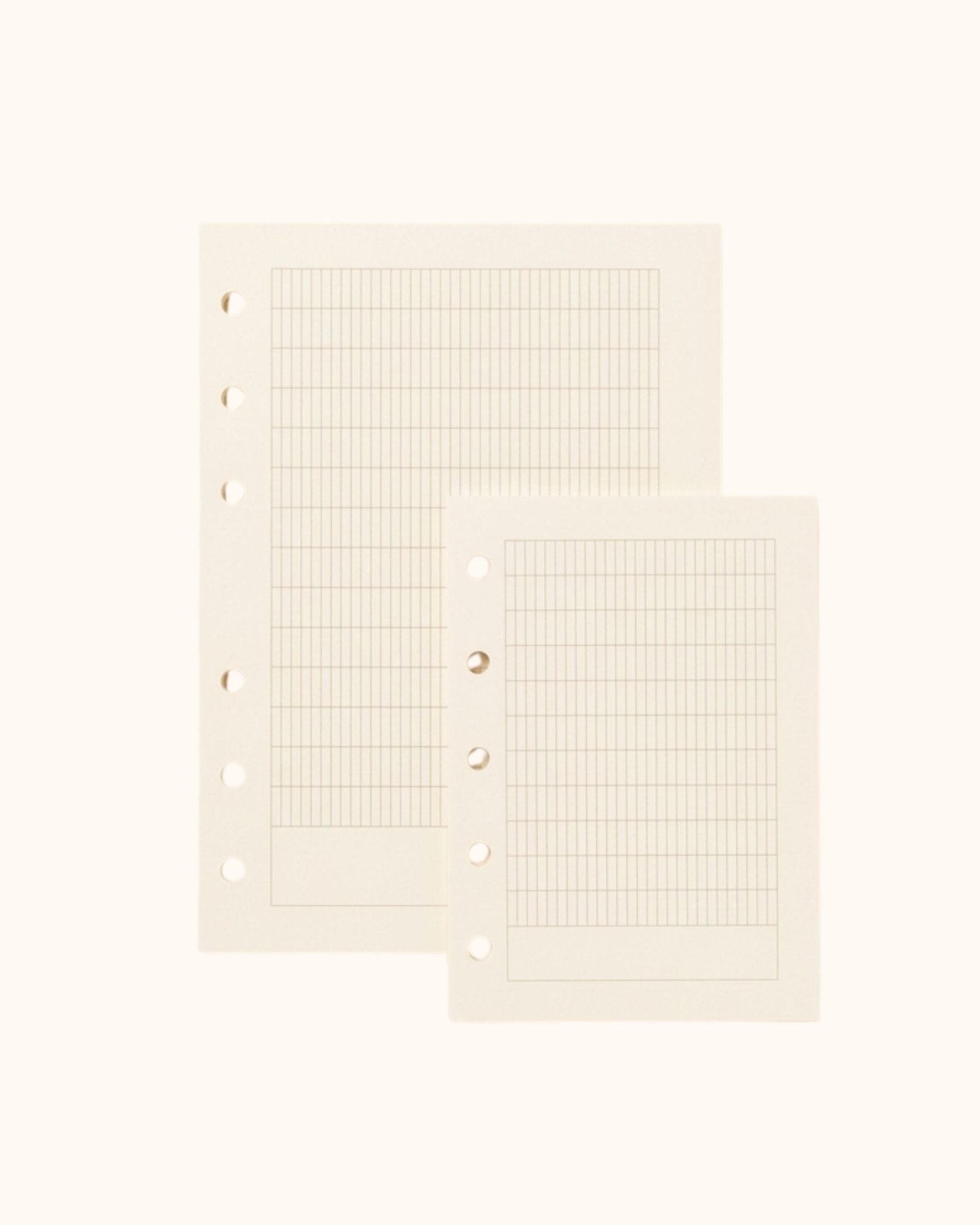 Overhead view of two Kuura premium French ruled (Seyes) journal refill sheets in A6 and A7 sizes. Showcasing the structured grid pattern with standard 5-hole and 6-hole punching, ideal for practicing elegant handwriting and calligraphy.
