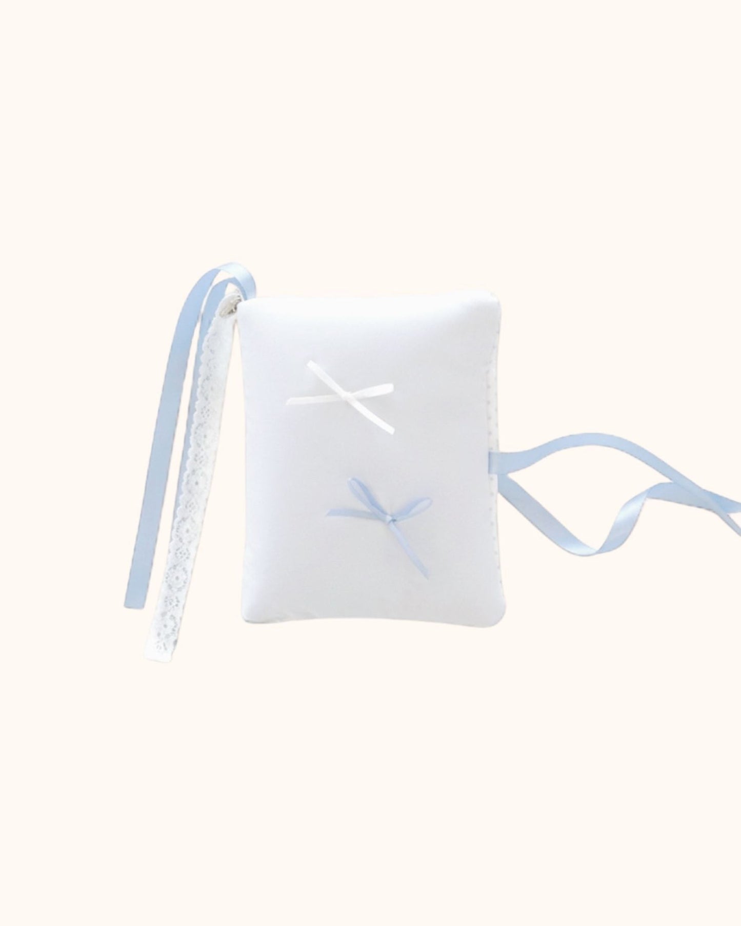 A pillow-soft kuura Balloon A6 Journal & Notebook Cover with Pockets in pastel misty blue. The coquette puffy diary sleeve is adorned with miniature white and misty blue bows, finished with a romantic white lace and matching blue ribbon wrap closure.