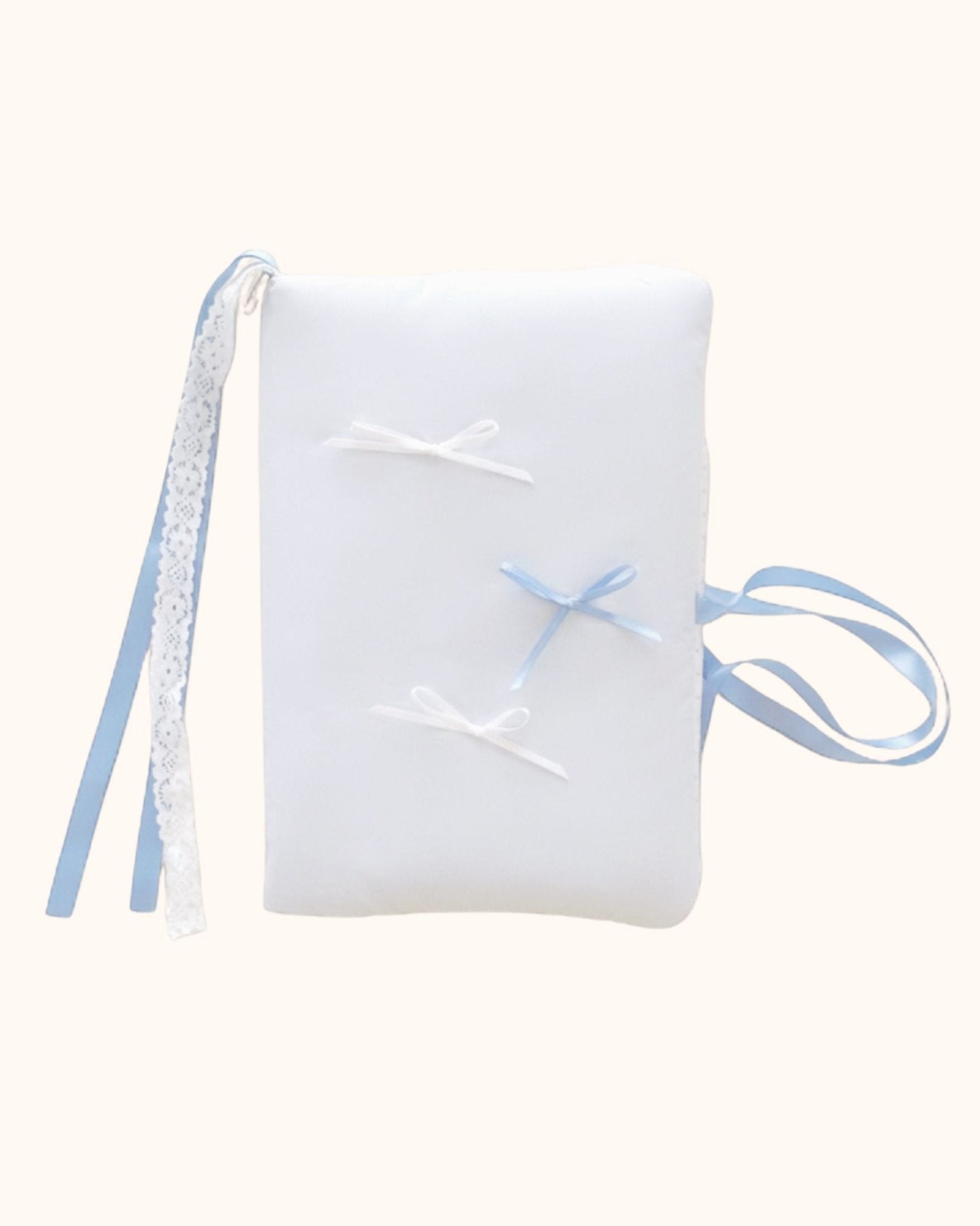 A tall and puffy kuura Balloon A5 Journal & Notebook Cover with Pockets in a soothing misty blue. This aesthetic notebook sleeve features a soft balloon texture, decorated with two white bows, one misty blue bow, elegant white lace, and trailing ribbon ties.