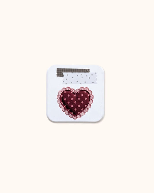 A cute aesthetic square trinket tin box in matte white, featuring a coquette style dotted burgundy heart and vintage washi tape collage. Perfect as a cute kawaii altoids wallet or desk organization.