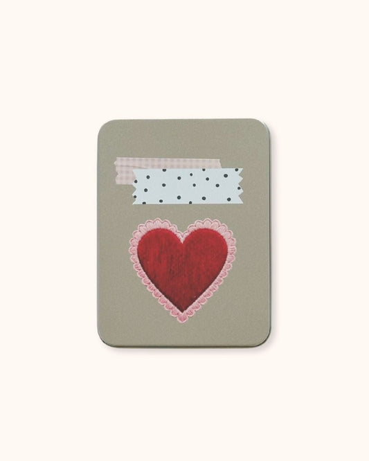 A large aesthetic tin box in silver, showcasing a Coquette red heart and retrograde washi tape collage on a minimalist textured surface. A functional and cute solution for deep desk organization.