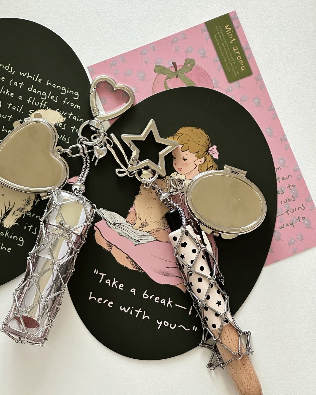 Kuura Macrame Journal Charm with Mirror, Heart and Star styles with silver net pouches and compact mirrors on illustrated journal cards. Y2K accessory