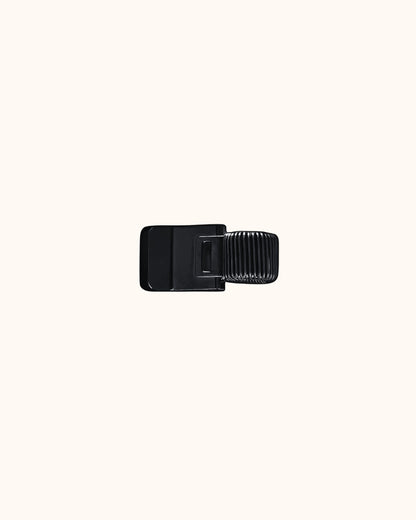 Kuura Minimalist Pen Loop in black, a slim metal clip that holds a pen on the cover. Minimalist pen holder for journal and notebook covers
