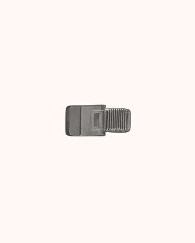 Kuura Minimalist Pen Loop in brushed silver, a slim metal clip that holds a pen on the cover. Doubles as a page marker for planners
