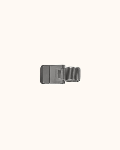Kuura Minimalist Pen Loop in brushed silver, a slim metal clip that holds a pen on the cover. Doubles as a page marker for planners
