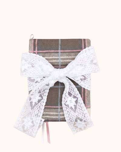 Kuura Museum Date A5 & A6 Journal & Notebook Cover in Brown Plaid, tied with an oversized ivory lace bow over the pink check. Coquette academia notebook