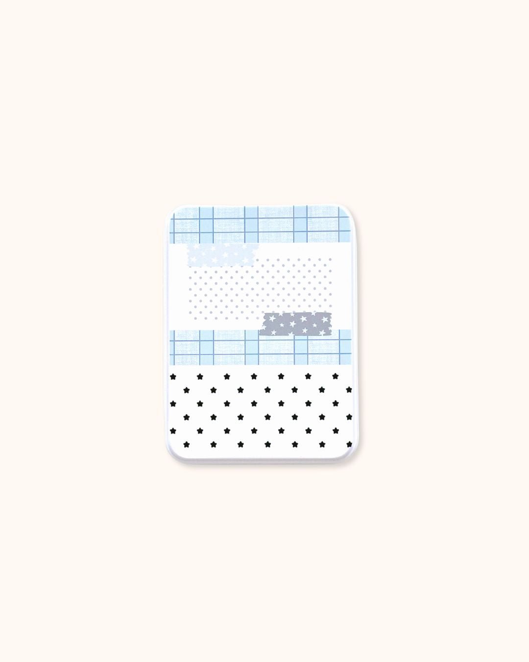 A medium aesthetic trinket tin box in matte white, decorated with a blue grid and star collage pattern.