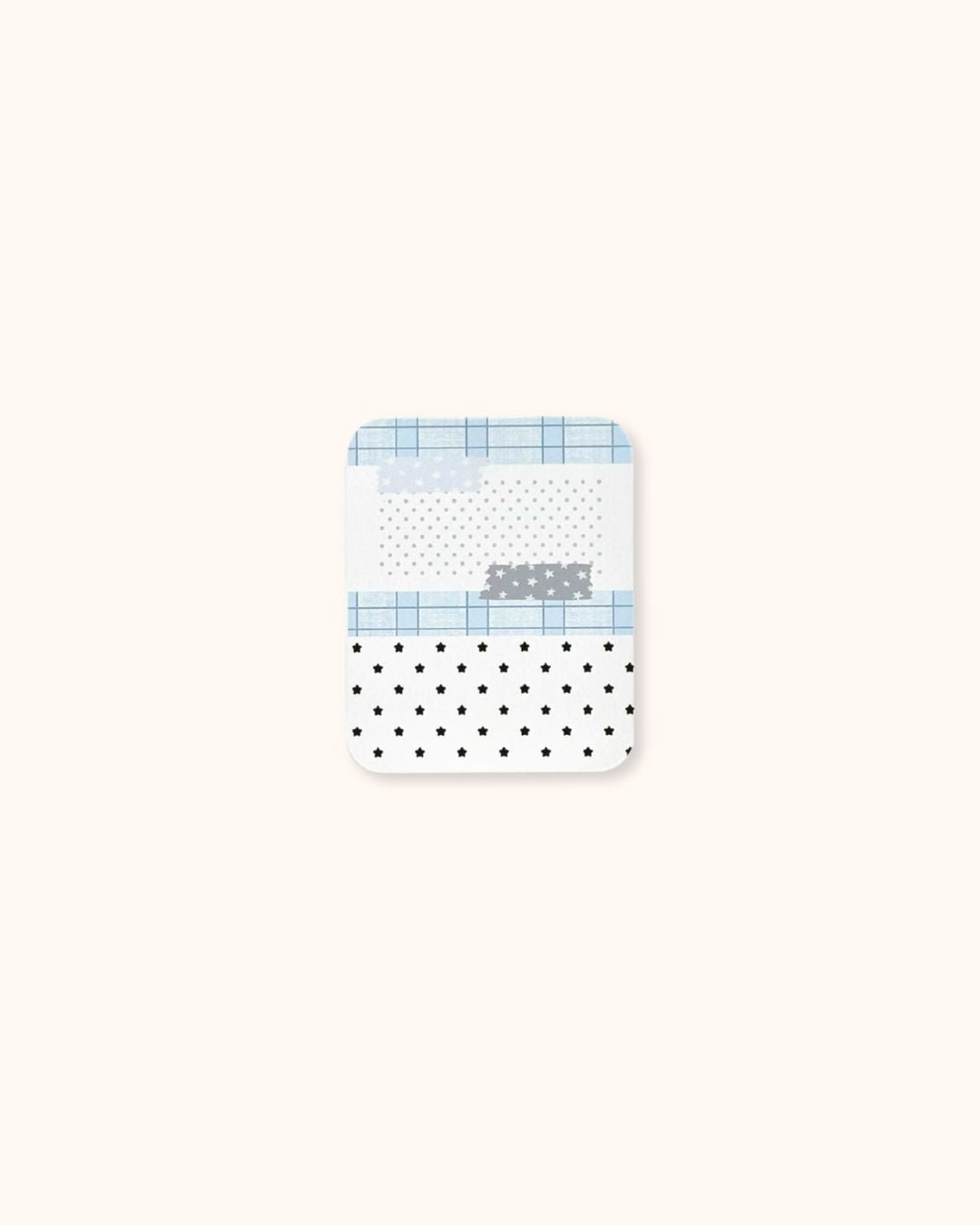 A small aesthetic trinket tin box in matte white, decorated with a blue grid and star collage pattern.