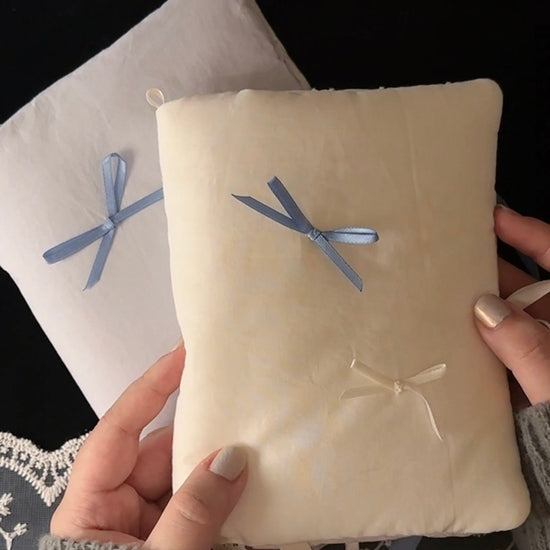 Balloon cotton journal cover shown with its bow untied and pocket, ribbon marker, and charm loop, then filled with pages