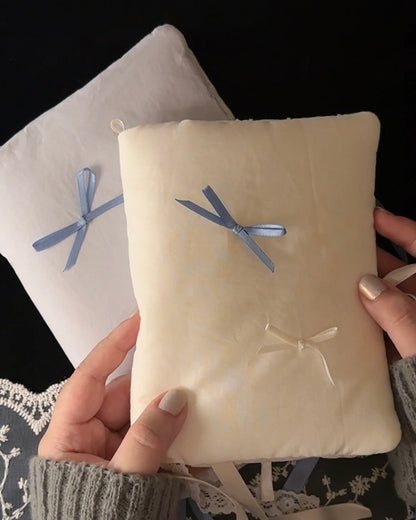 Balloon cotton journal cover shown with its bow untied and pocket, ribbon marker, and charm loop, then filled with pages