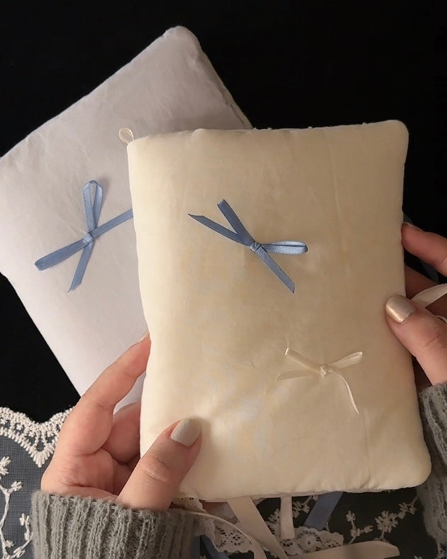Balloon cotton journal cover shown with its bow untied and pocket, ribbon marker, and charm loop, then filled with pages