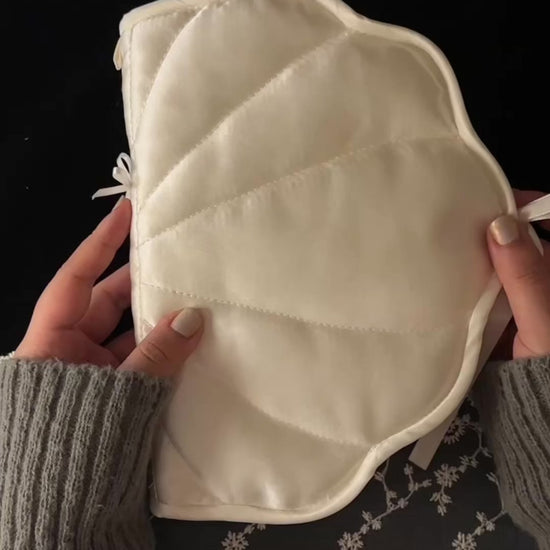 Shell-shaped satin journal cover shown with its charm loop and bow untied, then opened to reveal the 6-ring binder filled with pages