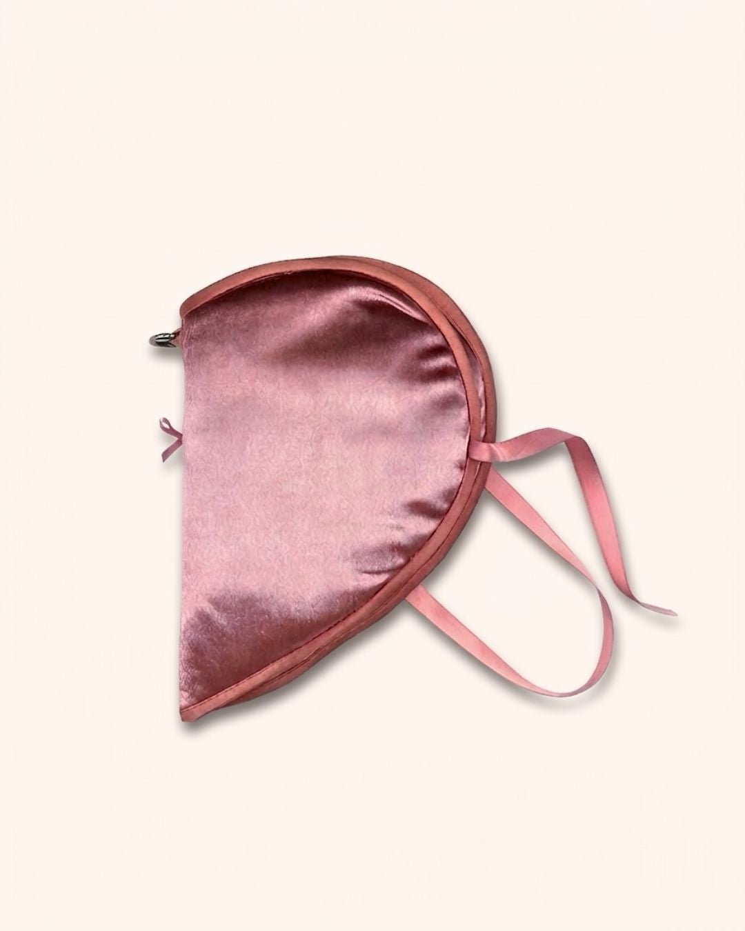 Close-up of glossy velvet fabric and soft cotton filling on Kuura’s Heart Shaped Secret Teatime A7 notebook sleeve. Highlighting the smooth pink fabric texture and delicate ribbon tie details.