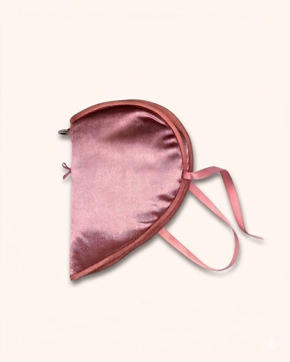 Close-up of glossy velvet fabric and soft cotton filling on Kuura’s Heart Shaped Secret Teatime A7 notebook sleeve.Angled view of the Secret Teatime A7 notebook sleeve, highlighting the smooth pink fabric texture and delicate ribbon tie details.