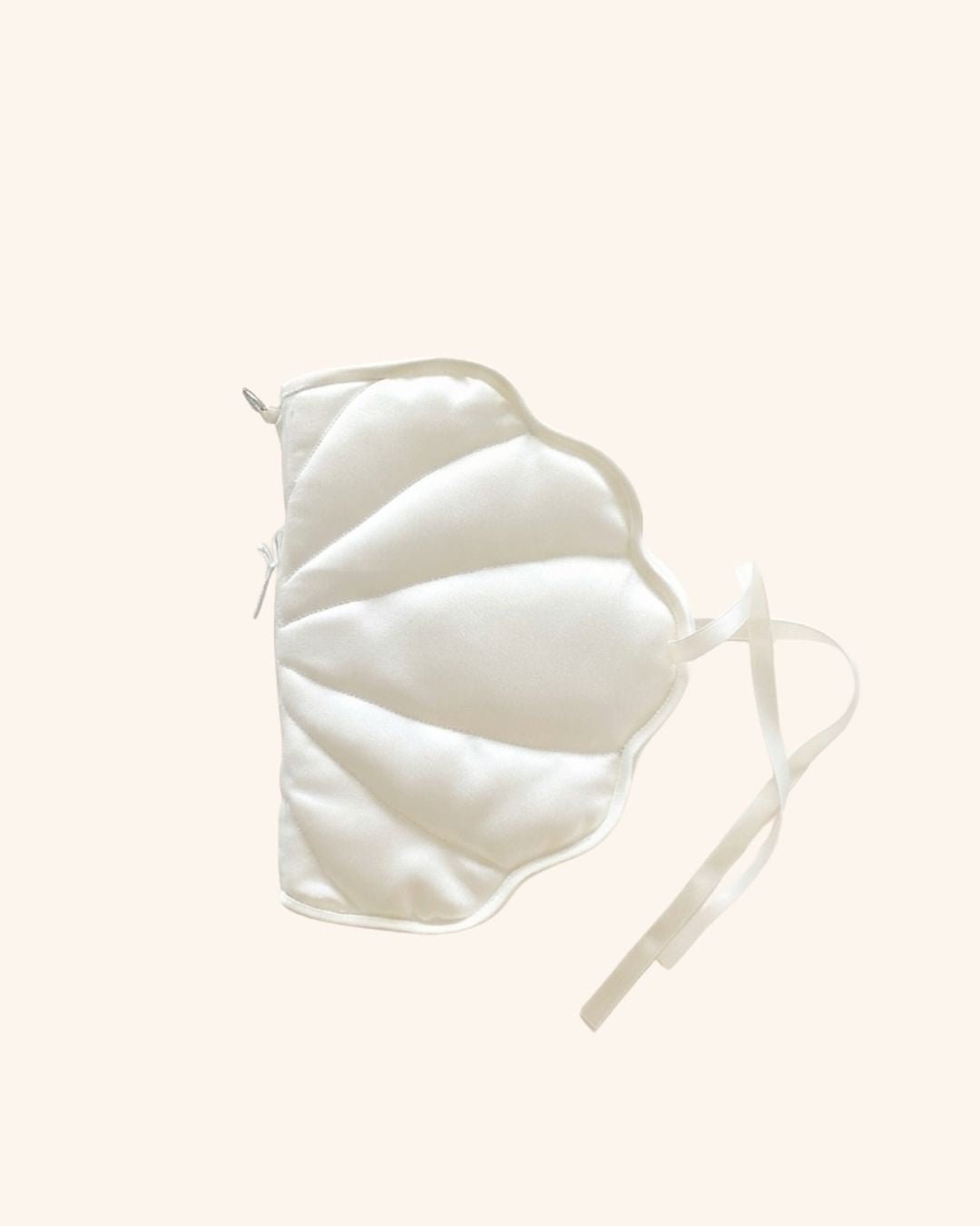 Kuura's shell shaped journa cover a pearl-colored soft pillowy huggable cover to protect notebooks and journals on a pale cream background