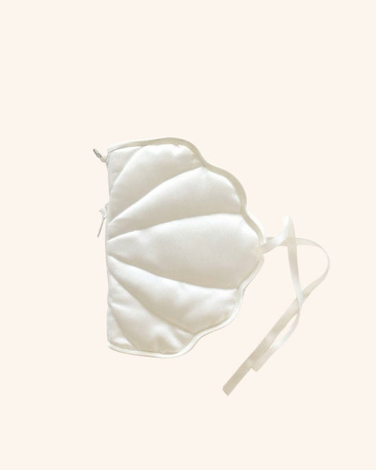Kuura's shell shaped journa cover a pearl-colored soft pillowy huggable cover to protect notebooks and journals on a pale cream background