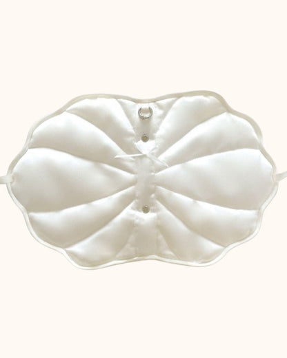 An outside look of the Kuura handmade shell-shaped A6 journal cover in pearl white, showcasing its puffy quilted texture, ribbon tie closures, and internal details. A unique and aesthetic refillable notebook sleeve for creative planning