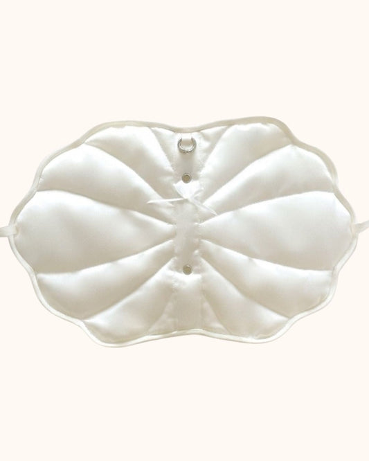 An outside look of the Kuura handmade shell-shaped A6 journal cover in pearl white, showcasing its puffy quilted texture, ribbon tie closures, and internal details. A unique and aesthetic refillable notebook sleeve for creative planning